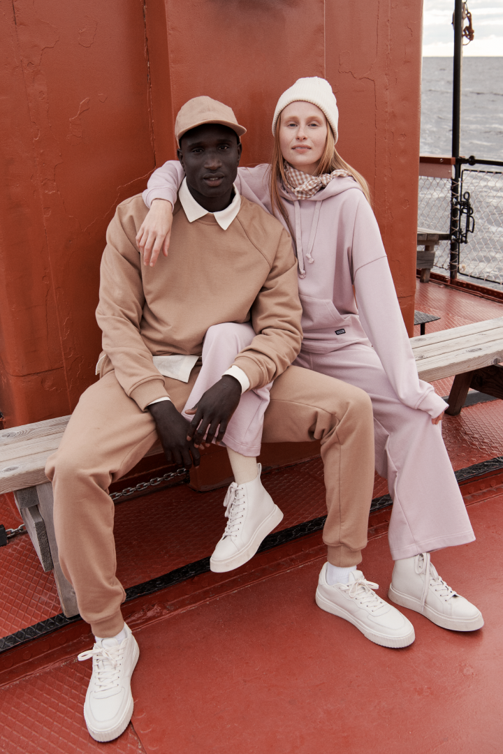Two persons on boat with R-collection clothing